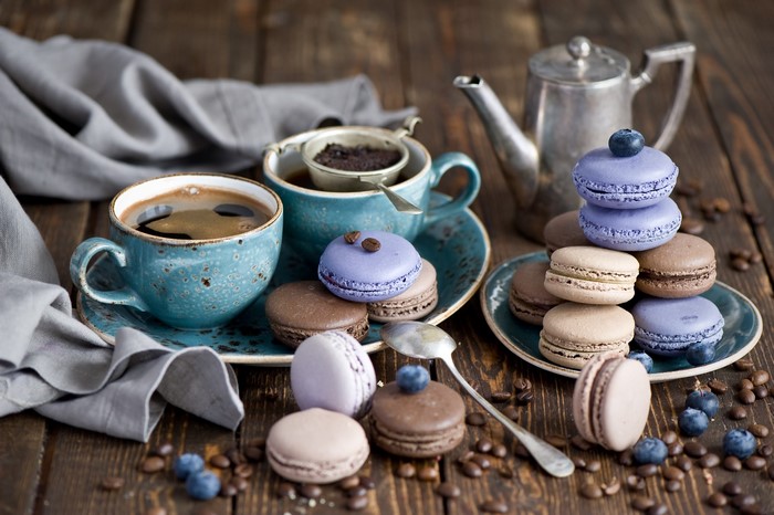 Coffee cups and macarons on a wooden table