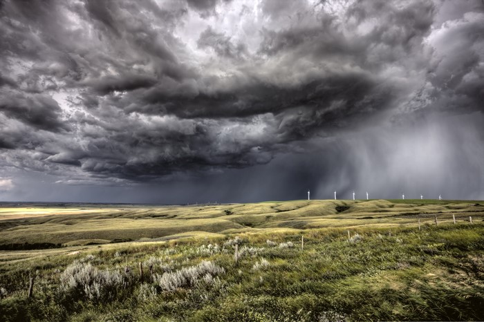 Stormy Sky over Canadian Fields with Wind Turbines