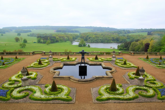 Formal garden with sculpture and lake view