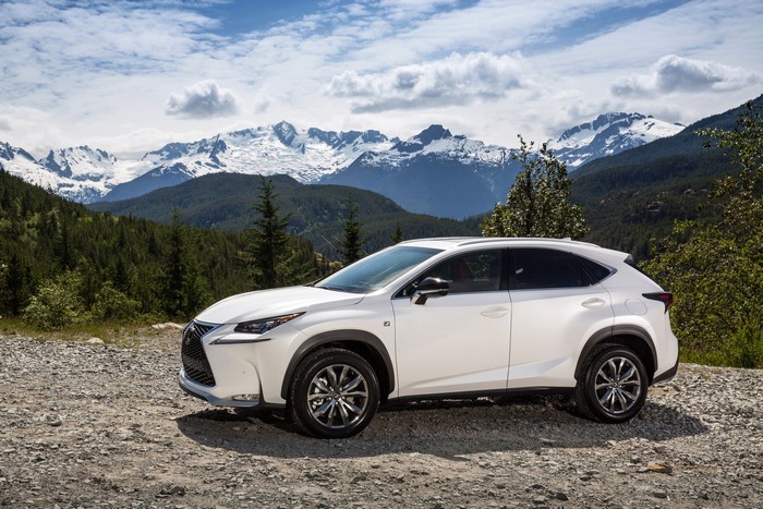 White Lexus NX 200t F-Sport parked with mountains