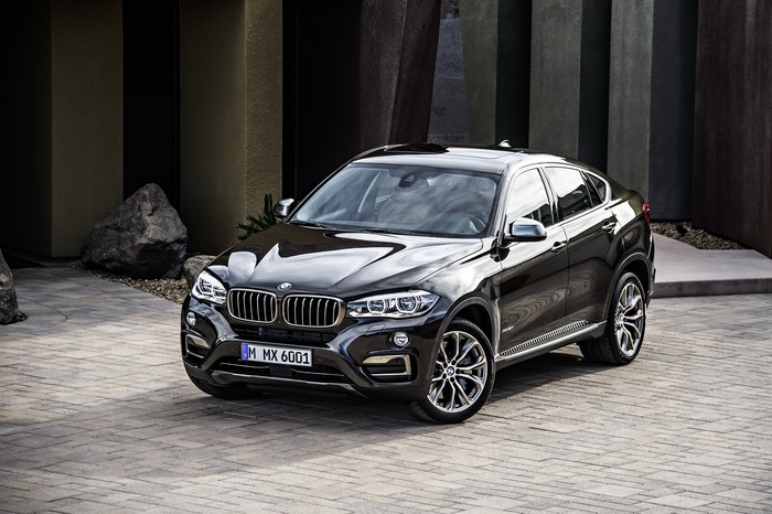 Black BMW X6 F16 xDrive50i parked on a paved driveway