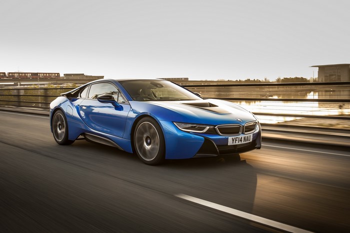 Blue 2014 BMW i8 driving on a road