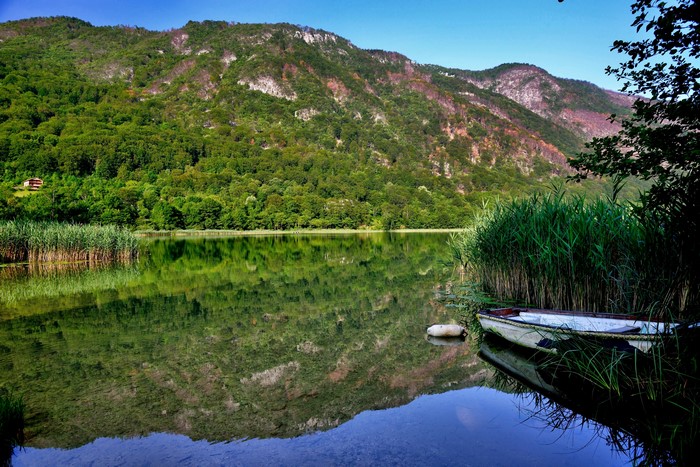 4K Boracko Lake in Bosnia and Herzegovina with Mountains and Boats