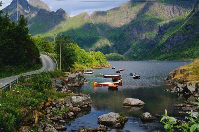 Boats on a lake with mountains and a road in Nordland Fylke, Norway
