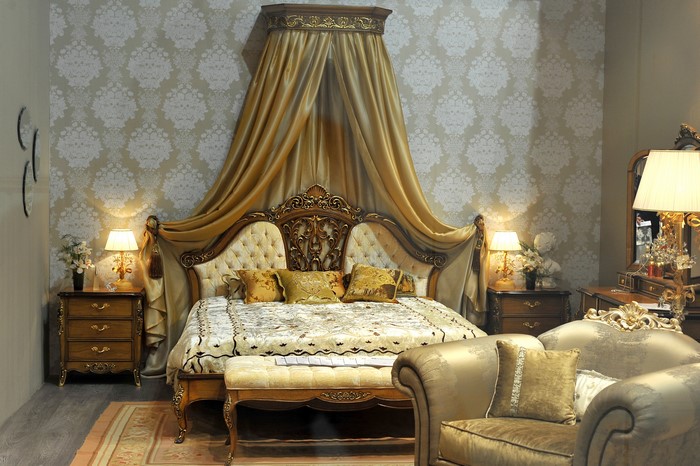 Luxurious bedroom with a canopy bed and ornate furniture