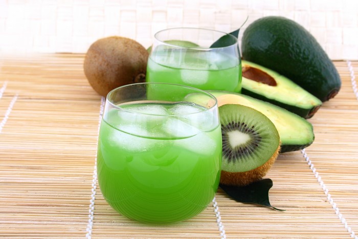 Kiwi and avocado juice with ice in glasses