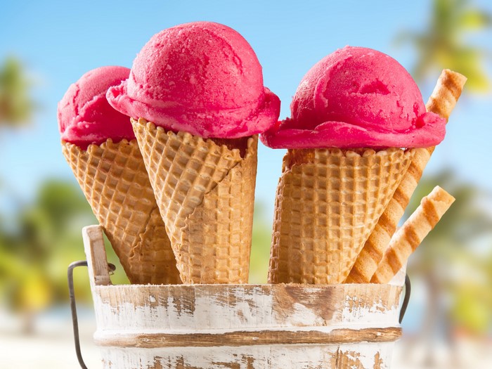 Three pink ice cream cones in a bucket