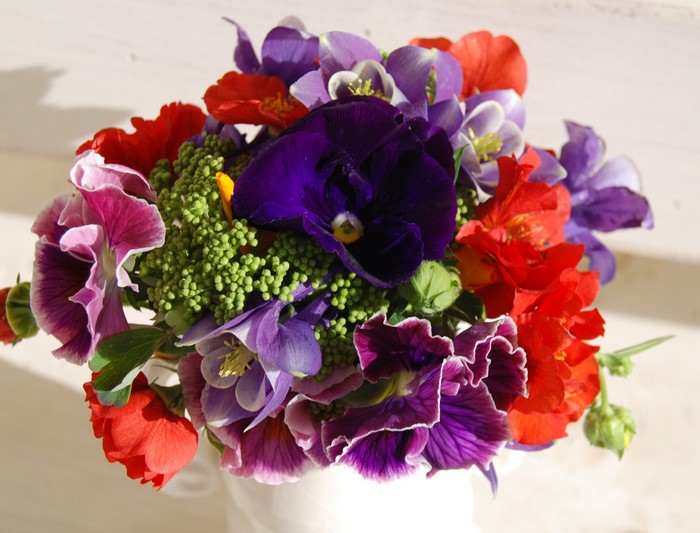 Bouquet of colorful flowers in a white vase