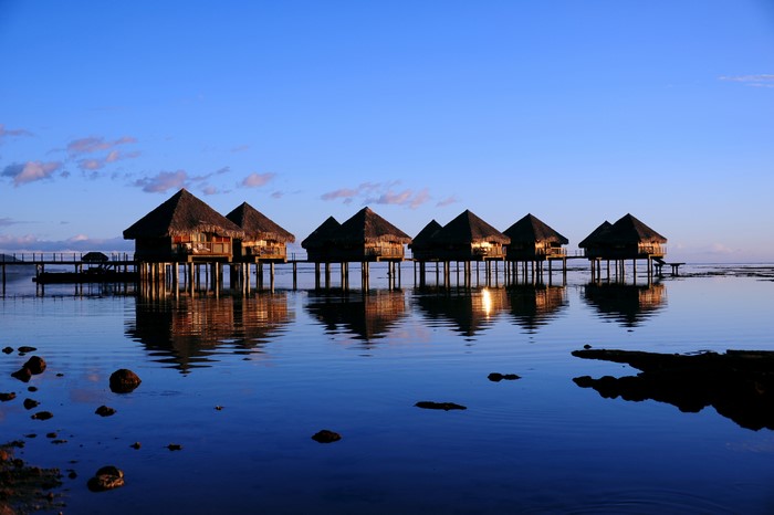 Overwater bungalows in Tahiti at sunset