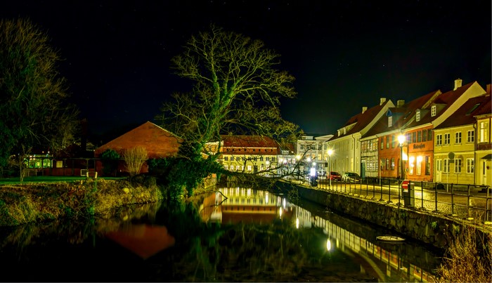 Houses along a canal at night in Nyborg, Germany