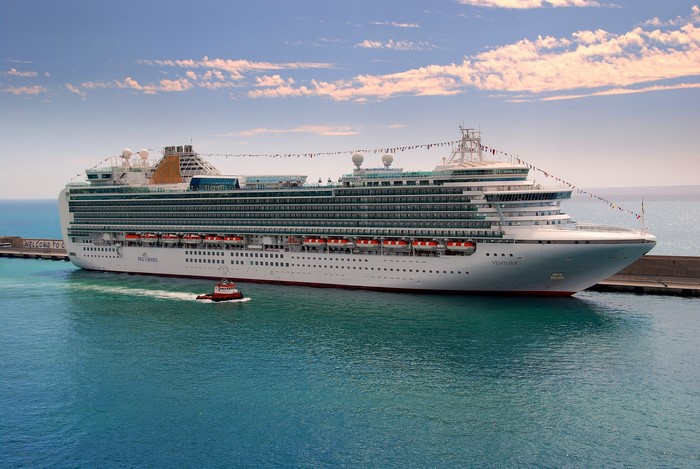 Cruise liner Ventura docked at port with tugboat