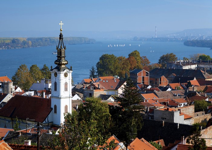Church tower overlooking a river and city in Serbia