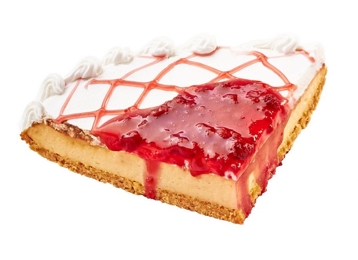 Slice of cheesecake with strawberry jam and whipped cream