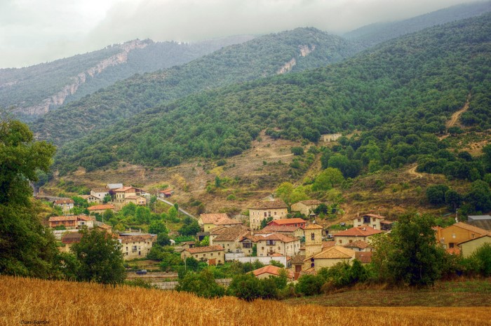 Village nestled in a green mountain valley in Spain