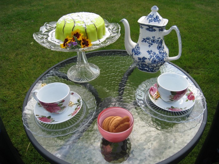 Afternoon tea with cake and cookies on a table