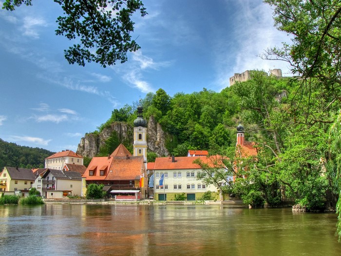 River town with church and castle ruins in Germany
