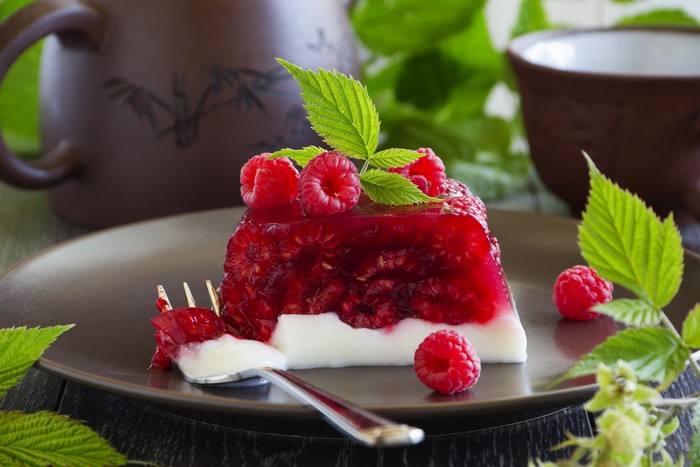 Raspberry jelly dessert with cream and fork