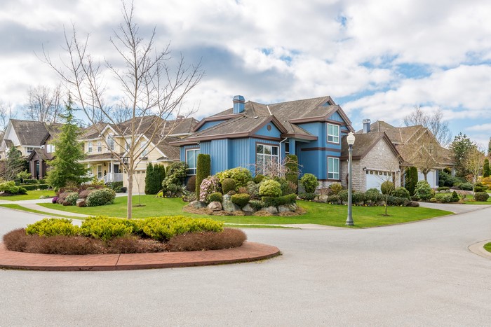 Suburban street with blue and stone houses
