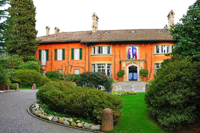 Orange building with flags and garden in Lugano, Switzerland