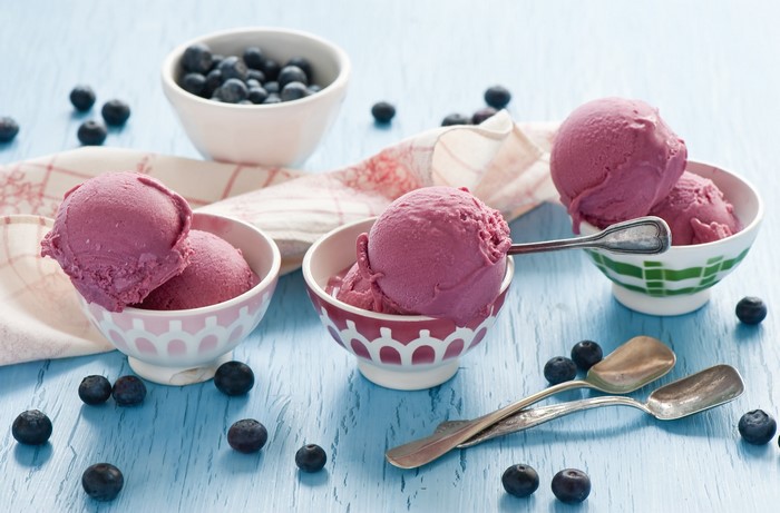 Blueberry ice cream in bowls with fresh blueberries