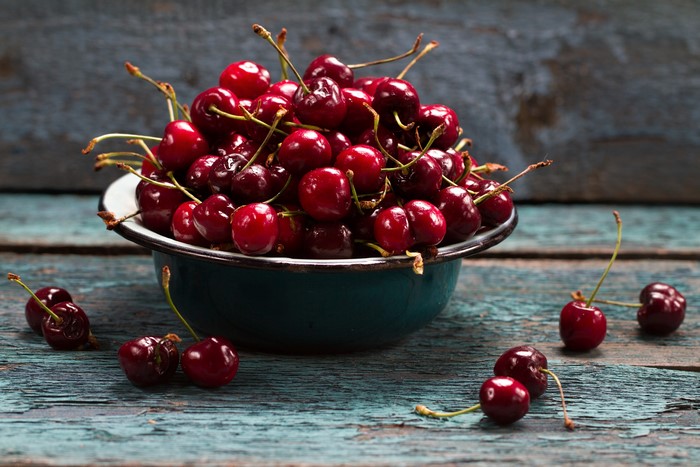 Bowl of Cherries on a Wooden Table