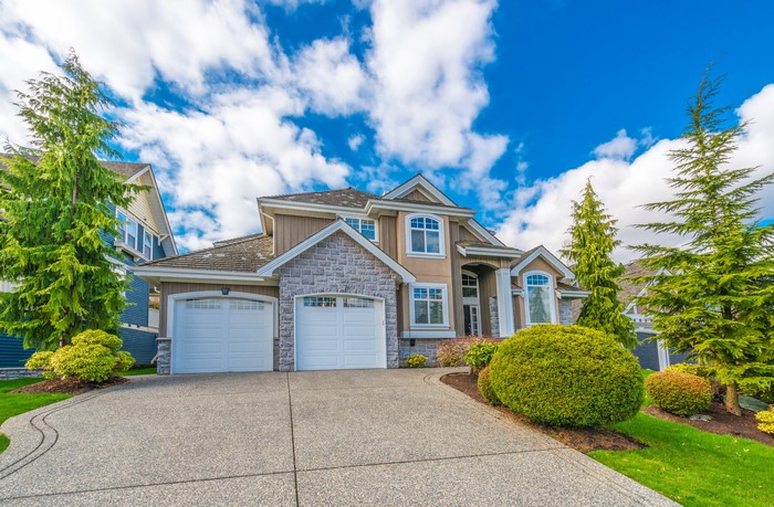 Luxury house with manicured lawn and trees