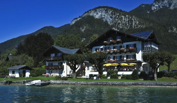 Houses on a lake in St Gilgen, Austria with mountains