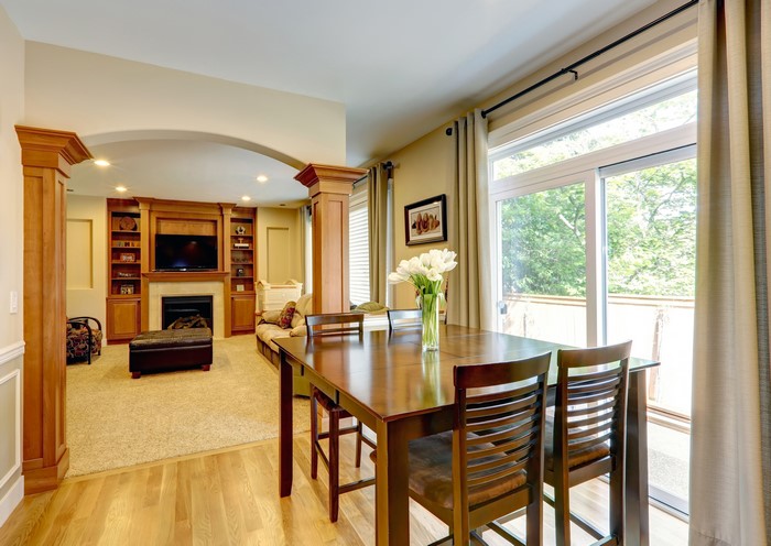 Dining table and chairs in living room with fireplace