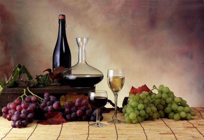 Wine bottle, decanter, and grapes with stemware