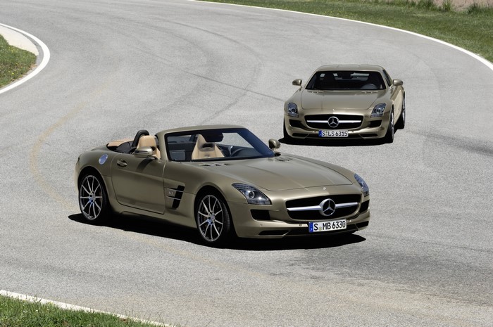 Two Mercedes-Benz SLS AMG roadsters on a road