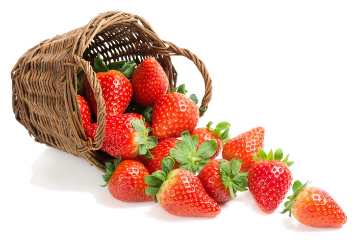 Strawberries spilling from a wicker basket