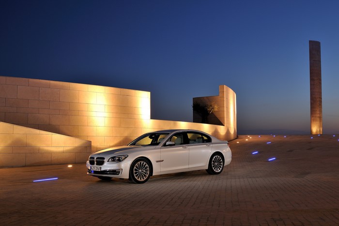 White 2012 BMW 750d F01 at night