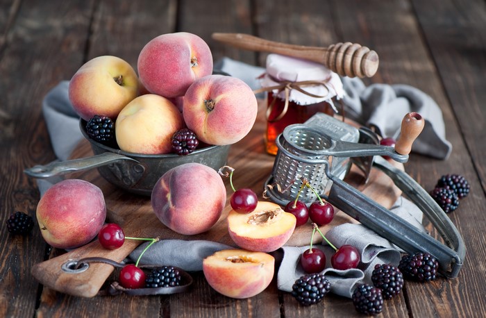 Peaches, Cherries, and Blackberries with Honey Jar and Grater