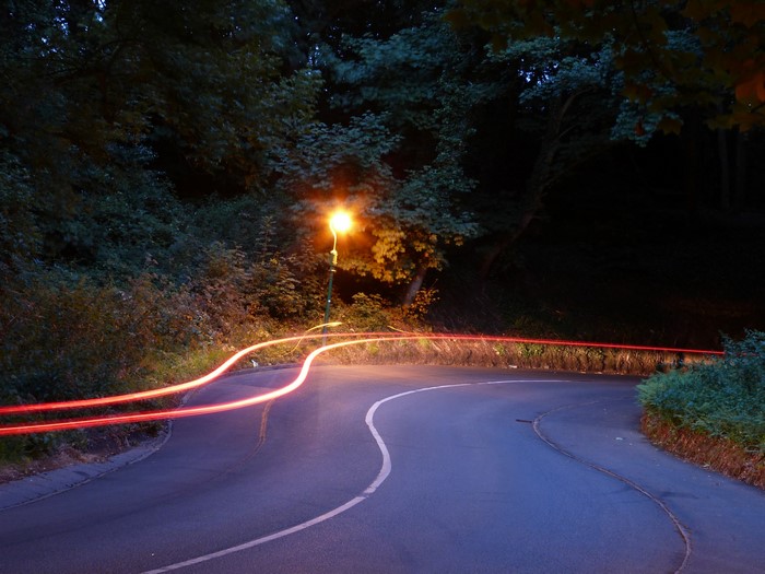 Road with light trails and street light at night