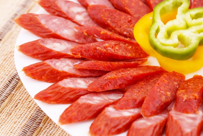 Sliced sausages and bell peppers on a plate