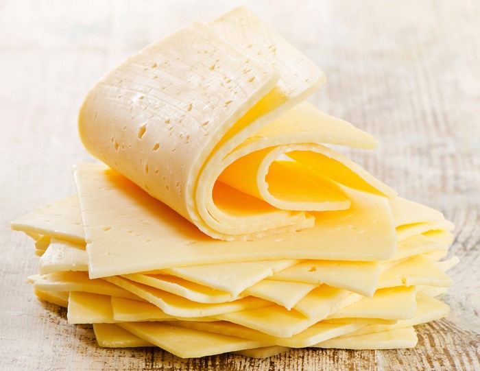 Stack of Sliced Cheese on Wooden Surface