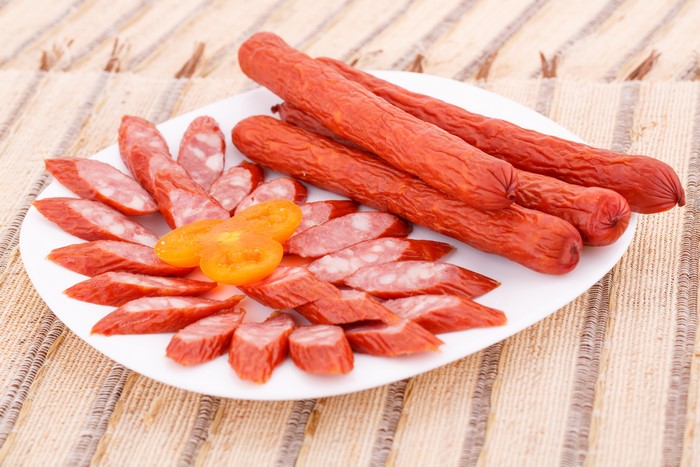 Sausage and tomato slices on a plate