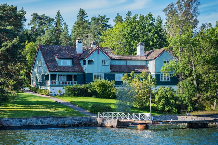 Blue house by the water in Sweden