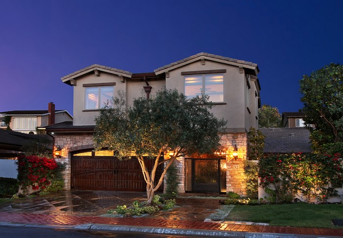 Luxury house at night with illuminated facade and garden