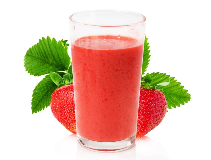 Strawberry smoothie in a highball glass with strawberries