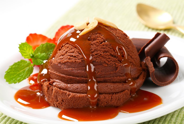 Chocolate ice cream with caramel and strawberries