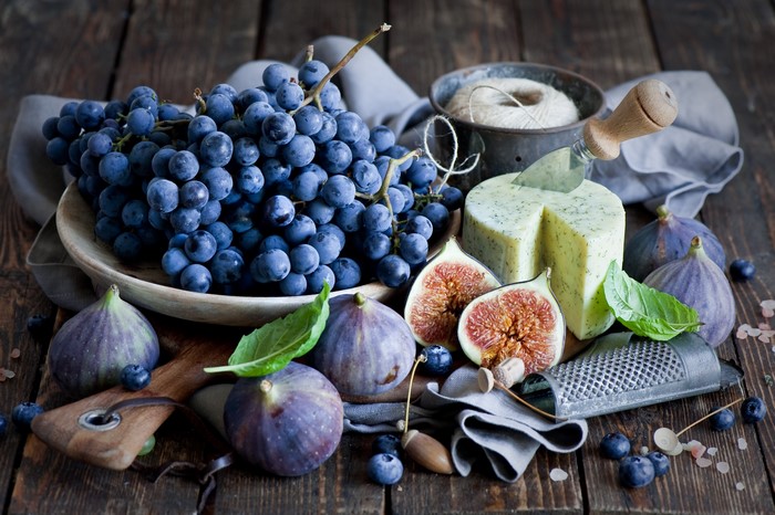 Still-life with grapes, figs, cheese, and blueberries