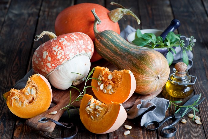 Pumpkins and herbs on a wooden table