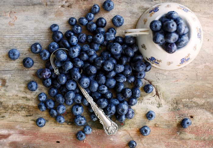Blueberries in a cup with a spoon