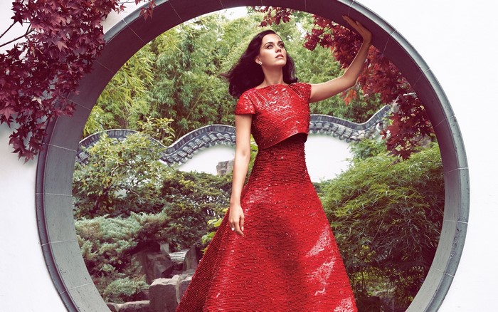 Katy Perry in a red dress in a garden