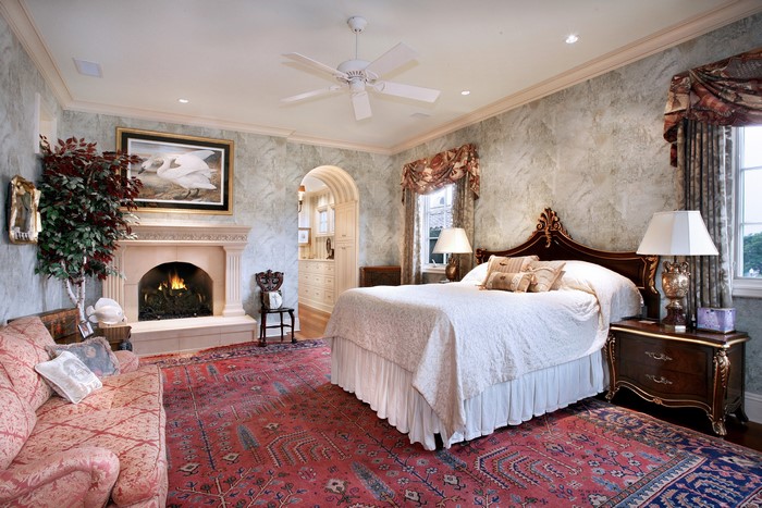 Bedroom with fireplace, sofa, and bed