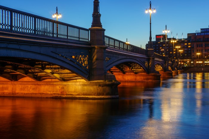 Bridge over water at night with street lights in Stockholm