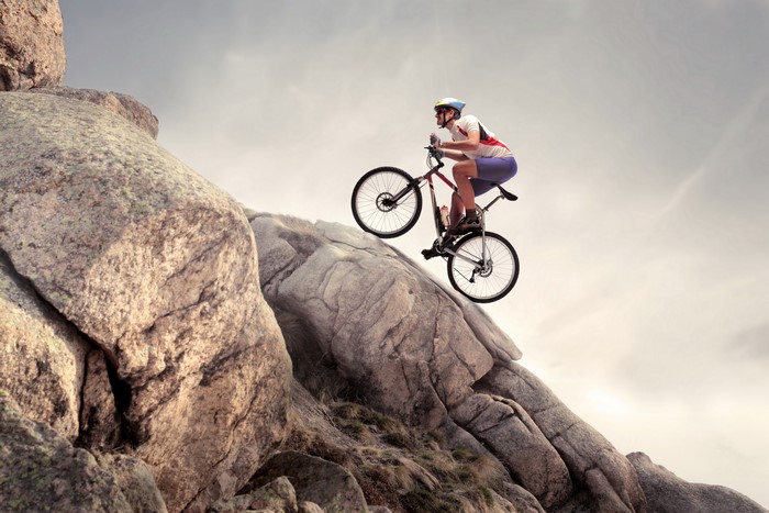 Man riding a bicycle on a rocky mountain