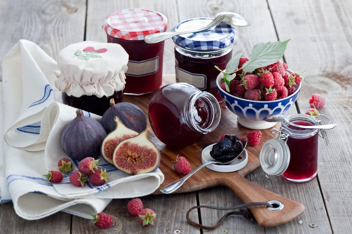 Jars of jam with raspberries and figs