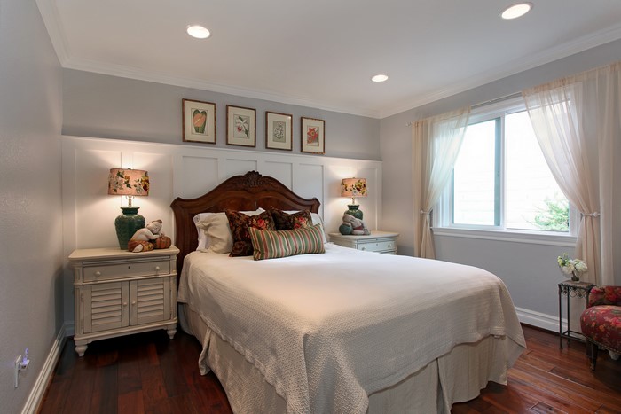 Bedroom with bed, nightstands, lamps, and window